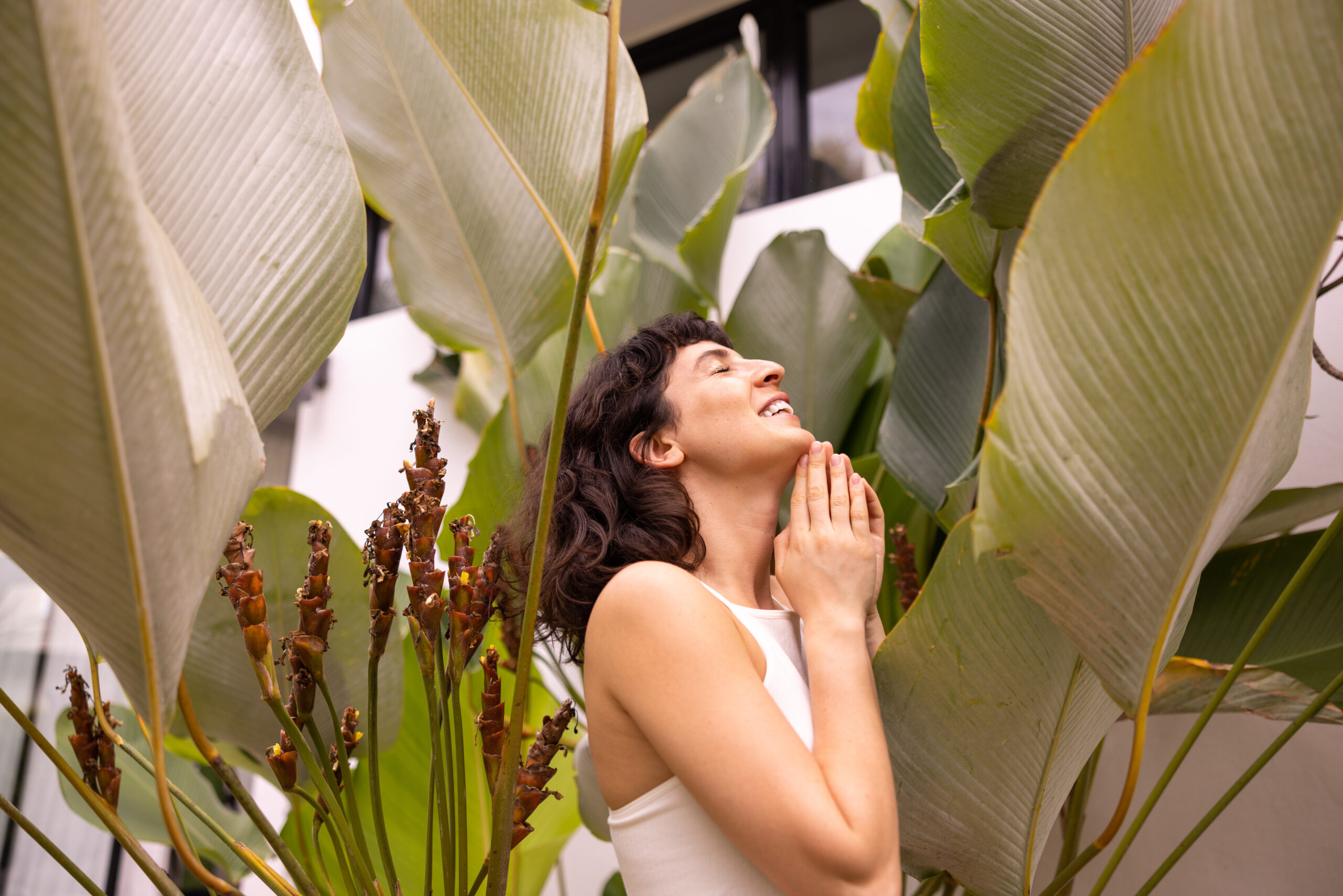 cute-caucasian-young-brunette-woman-with-closed-eyes-summer-top-stands-among-palm-leaves-concept-rest-recovery-2-scaled Personal Growth