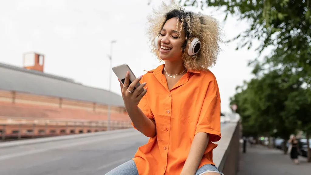 young-woman-with-smartphone-headphones-seo-1024x576 Authenticity and Transparency: Nurturing Trust Through Genuine Connections in Today's Digital Landscape